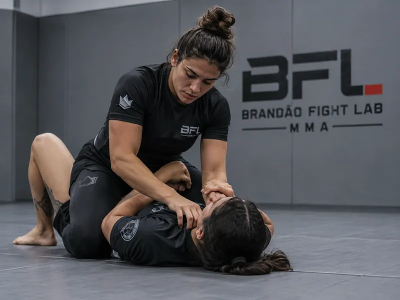 Women practicing grappling on the mat